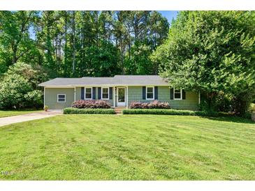 Charming one-story home with a well-maintained lawn and lush landscaping at 105 Choyce Ct, Garner, NC 27529