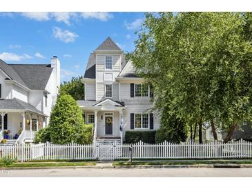 Charming two-story home featuring a beautiful white picket fence and well-manicured landscaping at 111 Chancellors Ridge Dr, Durham, NC 27713