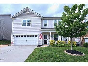 Charming two-story home with a well-manicured lawn and inviting front porch at 1254 Salters St, Burlington, NC 27215