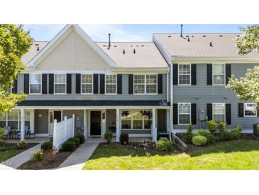Charming townhouse featuring gray siding, black shutters, and a well-manicured front yard at 1313 Legacy Greene Ave, Wake Forest, NC 27587