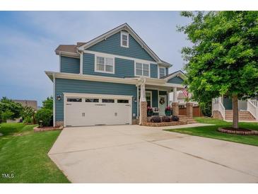 Beautiful two-story home featuring a two-car garage, brick-accented porch, and well-manicured lawn at 2020 Cotton Barn Ct, Wendell, NC 27591