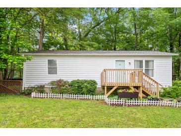 Charming single-story home featuring a wooden deck and well-maintained lawn at 2612 Wade Hampton Rd, Hillsborough, NC 27278