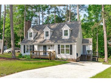 Charming Cape Cod-style home with a well-maintained lawn and inviting front porch, nestled among mature trees at 3 Haggis Ct, Durham, NC 27705
