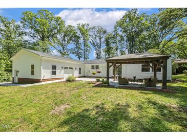Backyard with a large lawn and a gazebo with outdoor furniture at 418 S West St, Cary, NC 27511