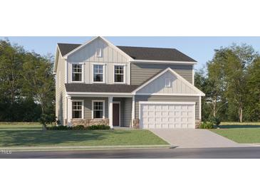 Charming two-story home featuring a two-car garage and a combination of stone and siding accents at 43 Regal Gardens Ct, Angier, NC 27501