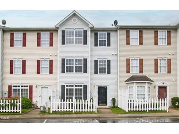 Traditional townhome featuring a white picket fence and well-maintained facade at 8610 Neuse Landing Ln # 103, Raleigh, NC 27616