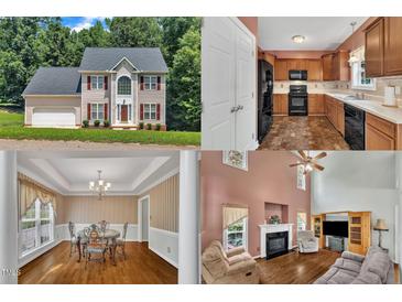 Charming two-story home featuring a symmetrical facade, complemented by red shutters and a well-maintained front yard at 1325 Red Brick Rd, Garner, NC 27529