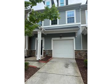 Charming townhome with a one-car garage and well-maintained front yard at 1671 Holly Grove Way, Durham, NC 27713