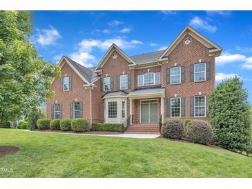 Beautiful red brick two-story home with manicured lawn and mature landscaping at 208 Bridle Boast Rd, Cary, NC 27519