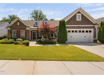 Charming single Gathering home featuring a well-manicured lawn and mature landscaping at 211 Ibis Ln, Durham, NC 27703