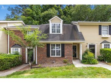 Charming townhome with brick and siding exterior, manicured lawn, and inviting entrance at 2233 Alpine Rd, Durham, NC 27707
