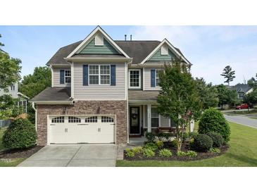 Charming two-story home featuring stone accents, a well-manicured lawn, and an attached two-car garage at 2361 Rainy Lake St, Wake Forest, NC 27587