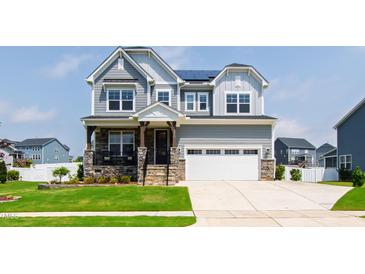 Charming two-story home with stone accents, inviting porch, and well-manicured lawn at 272 High Woods Rdg, Chapel Hill, NC 27517