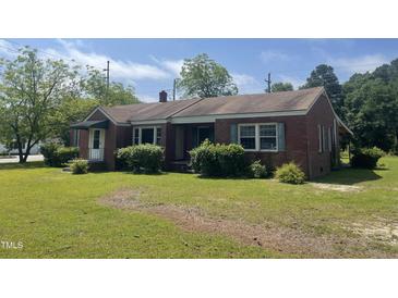 Charming single-story brick home featuring a well-maintained lawn and traditional architectural details at 3301 Amherst Rd, Rocky Mount, NC 27804