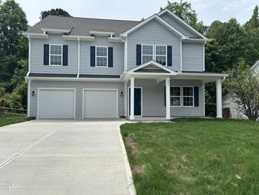 Charming two-story home with gray siding, blue shutters, and a two-car garage at 431 Mayview Dr, Creedmoor, NC 27522
