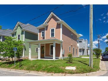 Charming two-story home with a front porch, manicured lawn, and inviting curb appeal at 500 Spruce St, Durham, NC 27703