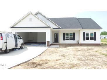 Charming single-story home featuring an attached garage, and classic curb appeal at 614 Tart Town Rd, Dunn, NC 28334