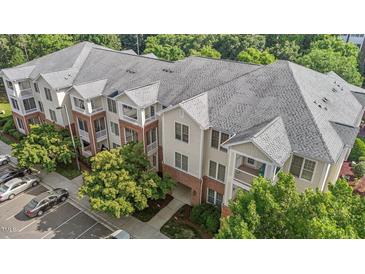 An aerial view of a multi-story condo building with brick and siding and private balconies at 735 Portstewart Dr, Cary, NC 27519