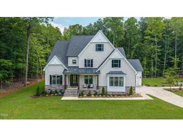 Beautiful two-story home featuring a manicured lawn, neutral color palette, and a welcoming front porch at 91 Ivy Ridge Rd, Chapel Hill, NC 27516