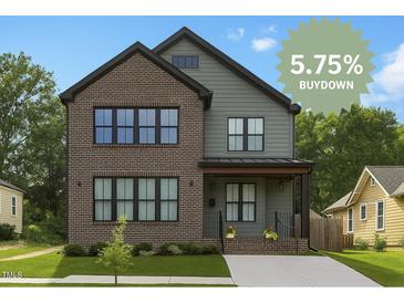 Charming two-story home featuring a mix of brick and siding, with a well-manicured lawn at 1405 Watts St, Durham, NC 27701