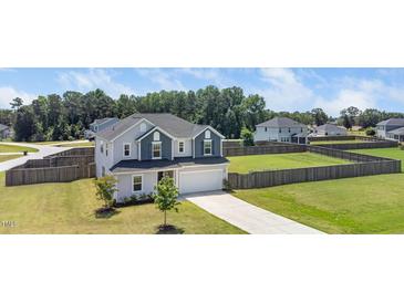Charming two-story home with a two-car garage, landscaped yard, and a spacious fenced backyard at 171 Piney Field Rd, Fuquay Varina, NC 27526