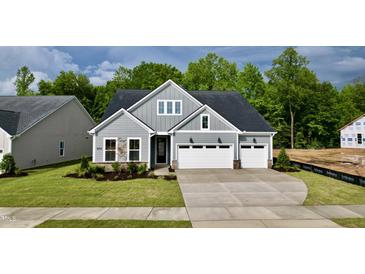 Charming craftsman-style home with a well-manicured lawn and attached three car garage at 2313 Abbeyhill Dr # 3, Raleigh, NC 27610