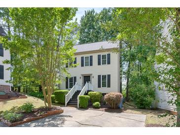 Charming two-story home with a well-manicured front yard, complimented with trees at 6 Weathergreen Ct, Durham, NC 27713