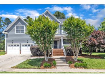 Charming two-story home featuring a manicured lawn, attached garage and classic architectural details at 805 Alden Bridge Dr, Cary, NC 27519