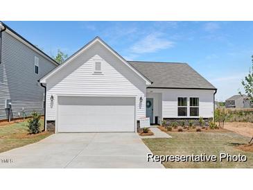 Charming single-story home with a white exterior, attached garage, and manicured front lawn at 94 Mable Court # 16, Lillington, NC 27546
