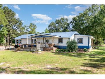 Charming single-story home with blue metal roof and covered front porch at 155 G Herring Rd, Princeton, NC 27569