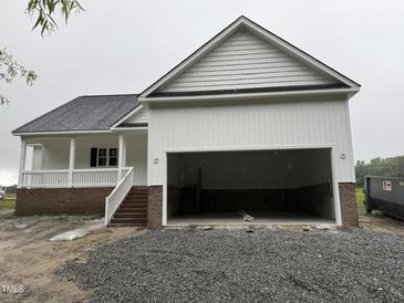 New home featuring a spacious two-car garage with carriage doors and traditional architecture at 168 Clayton Rd, Princeton, NC 27569