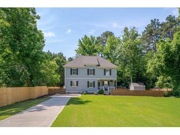 Charming two-story home featuring a manicured lawn, classic design, and inviting curb appeal at 3003 University Dr, Durham, NC 27707