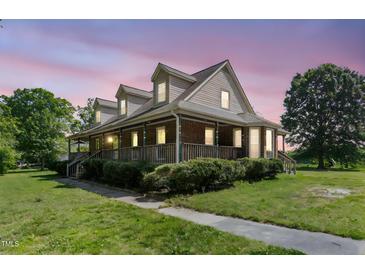Charming two-story brick home with a large wrap-around porch and dormer windows at 319 Knox Rd, Gibsonville, NC 27249