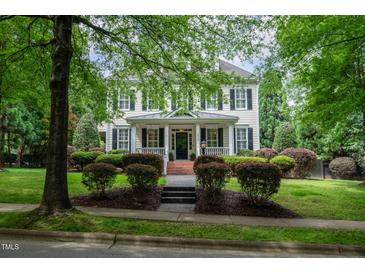 Charming two-story home with black shutters, brick front steps, and professionally landscaped yard at 3325 Falls River Ave, Raleigh, NC 27614