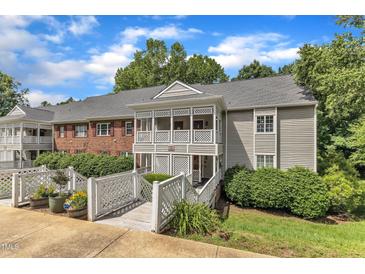 Inviting condo with a covered porch, walkway, and well-maintained landscaping on a sunny day at 501 Gooseneck Dr # B2, Cary, NC 27513