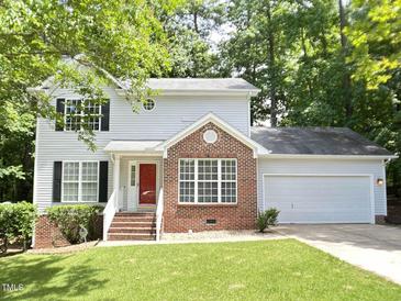 Charming two-story home with a red brick facade, complemented by a lush green lawn and an attached two-car garage at 109 Elmview Dr, Cary, NC 27519