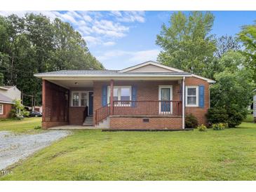Charming one-story brick home with a cozy front porch and well-maintained lawn at 1416 Chestnut St, Roxboro, NC 27573