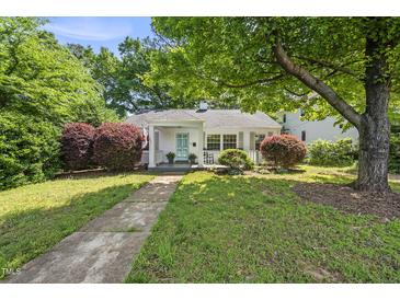 Charming home featuring a quaint porch, well-manicured landscaping, and inviting curb appeal at 1812 Hilton St, Raleigh, NC 27608