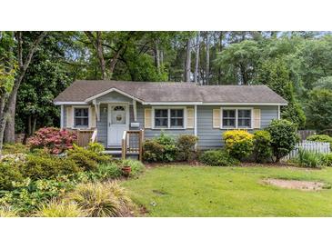 Charming single-story home featuring a lush, landscaped front yard and inviting entrance at 205 W Oak Ave, Wake Forest, NC 27587