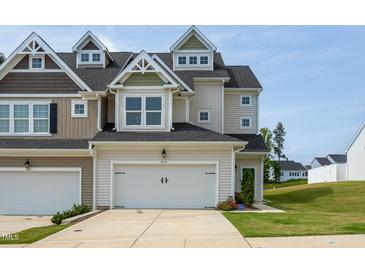 Attractive two-story home featuring a two-car garage, well-maintained landscaping, and inviting curb appeal at 228 Shingle Oak Rd, Wake Forest, NC 27587
