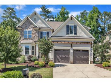 Beautiful two-story home with stone and siding, a two-car garage, and well-manicured landscaping at 3108 Lawson Walk Way, Rolesville, NC 27571
