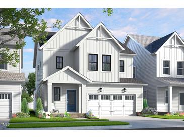 Charming two-story white home with black window trim, garage, and landscaped front yard at 323 Beacon Dr, Pittsboro, NC 27312