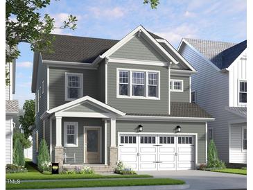 Charming two-story home with a covered porch, gray siding, white trim and a two car garage at 335 Beacon Dr, Pittsboro, NC 27312