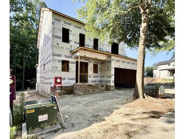 New construction featuring an unfinished exterior, showing building wrap and exposed framework on a sunny day at 3824 Coach Lantern Ave, Wake Forest, NC 27587
