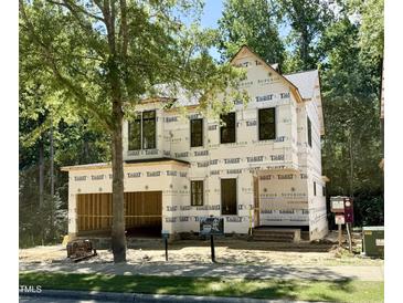 New construction home features black framed windows and unfinished exterior with yard sign at 3828 Coach Lantern Ave, Wake Forest, NC 27587