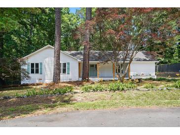 Charming single story home featuring a manicured front yard, inviting front porch, and lovely trees at 3916 W Allen, Raleigh, NC 27603