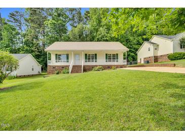 Charming single-story home with a welcoming front porch and lush green lawn at 404 Southerby Dr, Garner, NC 27529
