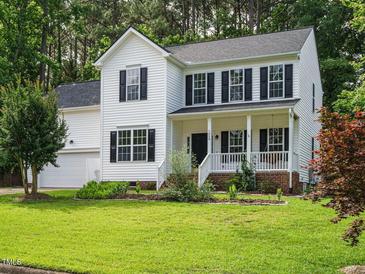 Charming two-story home with a well-maintained lawn and inviting front porch at 1010 Starita Ct, Apex, NC 27502
