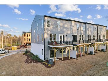 View of the exterior with balconies of these newly built townhomes ready for new owners at 10518 Pleasant Branch Dr # 38, Raleigh, NC 27614