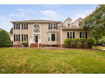 Charming two-story home boasts manicured lawn, dormer windows, and classic architectural details at 111 Gingergate Dr, Cary, NC 27519